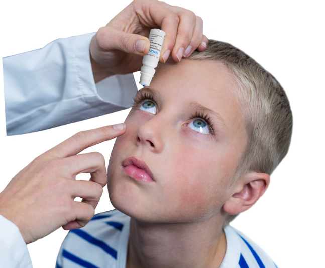 boy having eyedrops applied