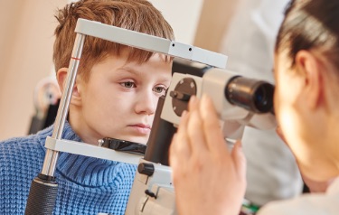 child receiving eye exam child receiving eye exam