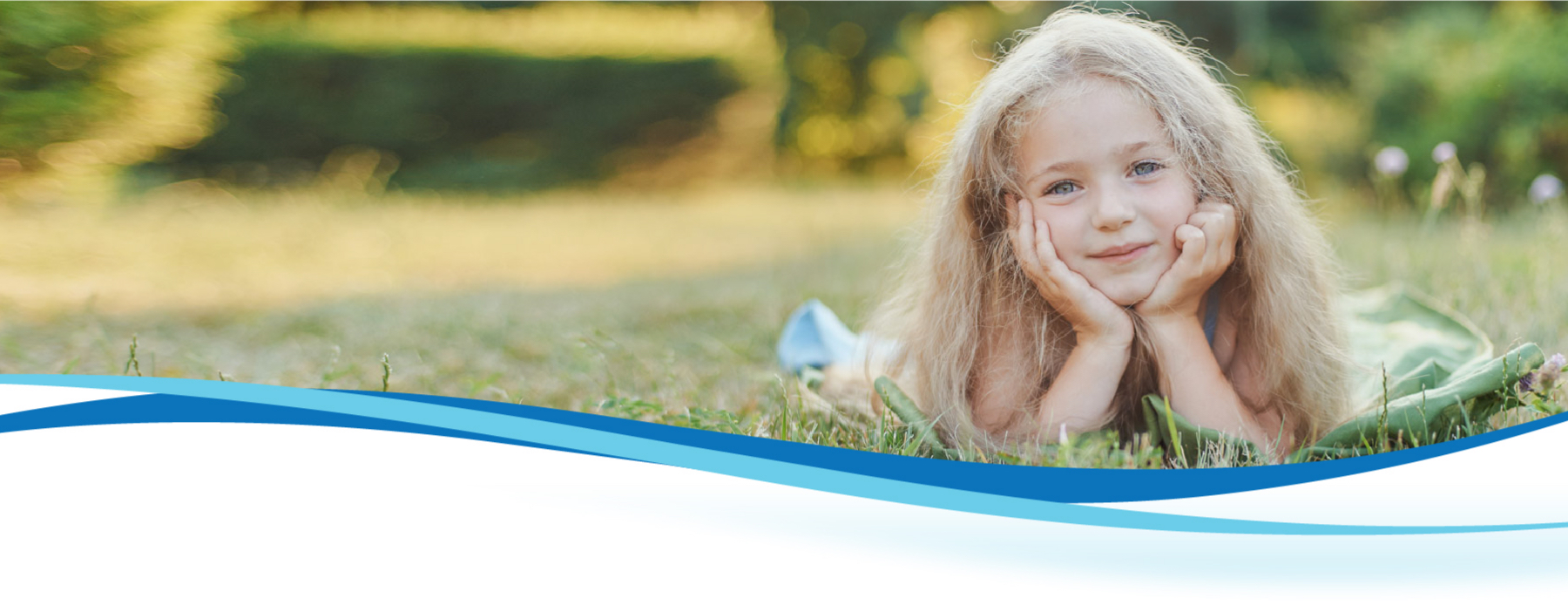 girl lying on grass smiling