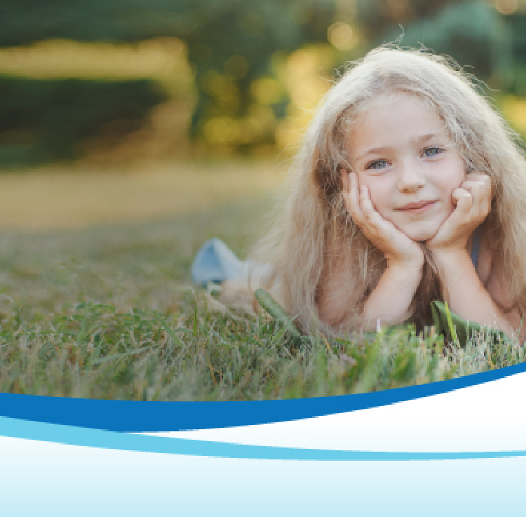 girl lying on grass smiling