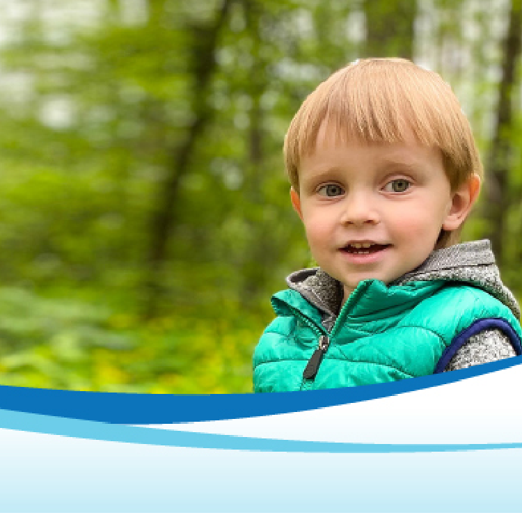 boy in forest looking at camera