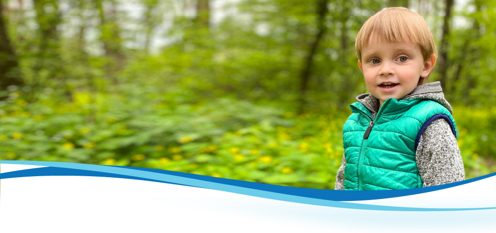 boy in forest looking at camera