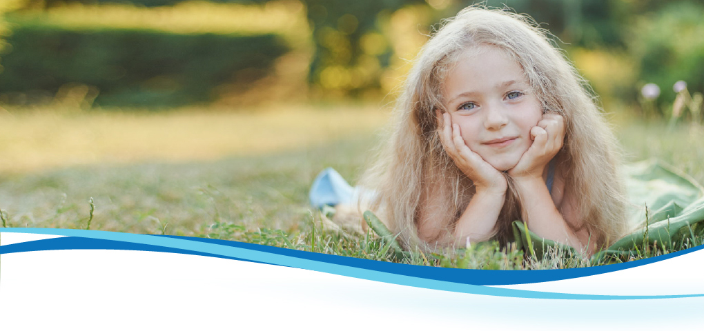 girl lying on grass smiling